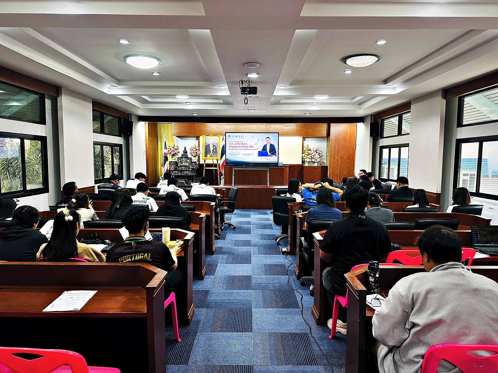 Participants seated in the Bang Yai Municipality meeting hall during a presentation on the front screen